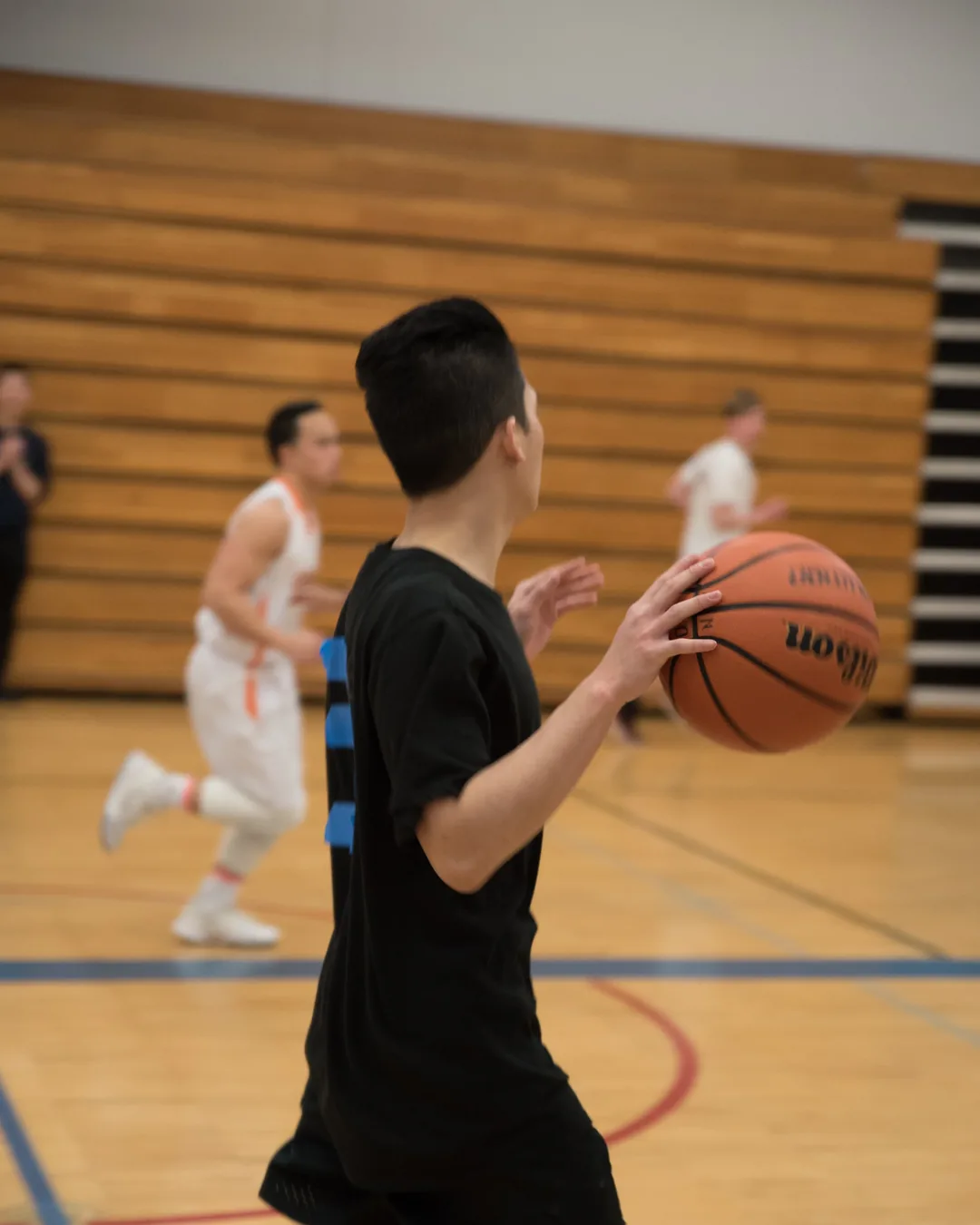 A player dribbling the ball up the court during a PERMIAS Cup game